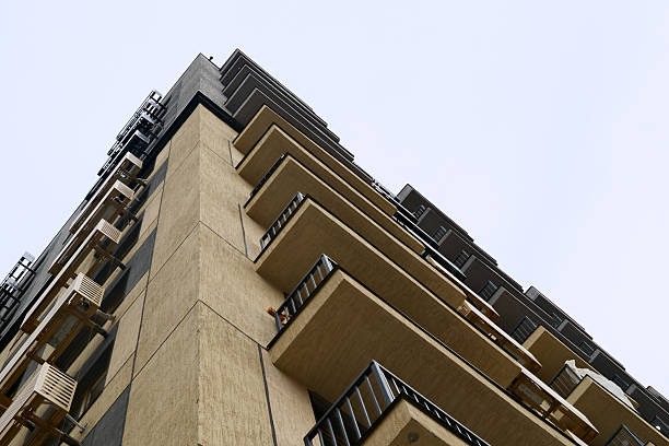 istock Modern residential high-rise building with balconies and air conditioning units, low angle view against clear sky 2208760321