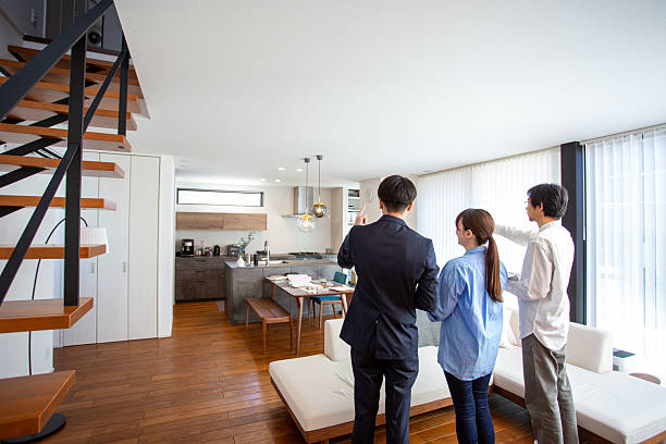 istock Housing sales: Salesman showing a model room, back view 2208765691