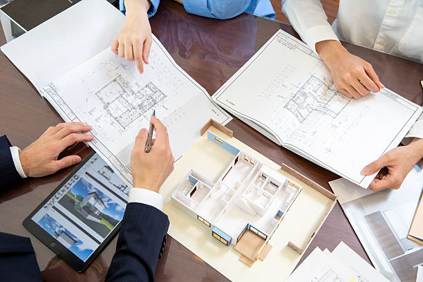 istock Housing sales meeting scene design drawing at hand no face 2208765770
