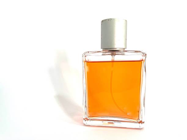 istock Glass perfume bottle with orange liquid and silver cap 2208768302