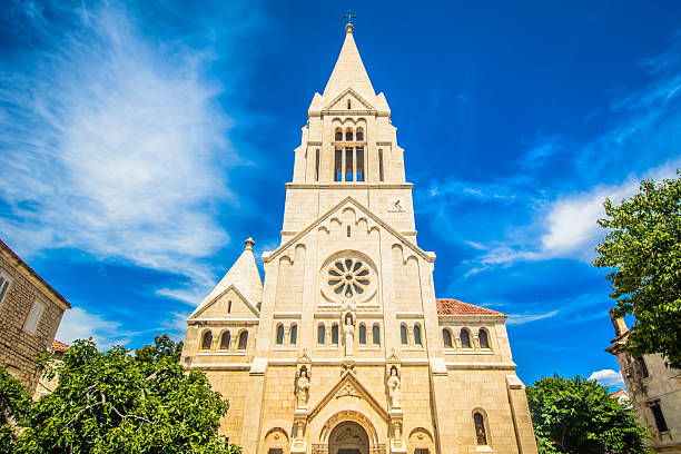 Scenic view of Old Landmark in Selca Village, Brac Island, Croatia A traditional stone parish church stands in the peaceful village of Selca on Brac Island, Croatia, surrounded by charming architecture and Mediterranean greenery in a serene setting old catholic church on island brac croatia stock pictures, royalty-free photos & images