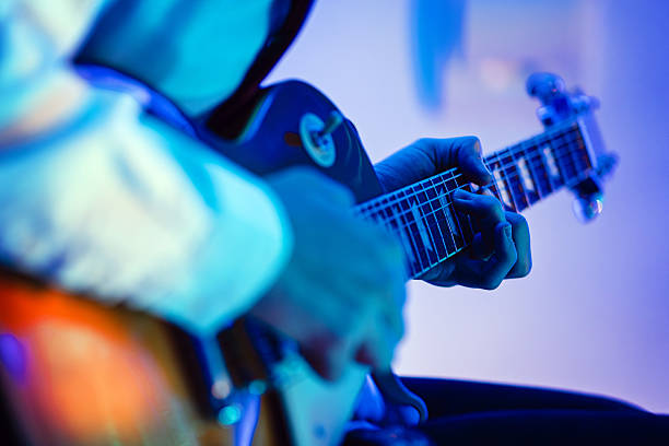 istock Guitarist Playing Electric Guitar on the Stage 2208770472