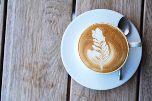 istock cup of coffee on wooden table, table top view 2208771965