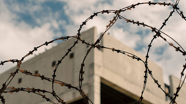 istock rusty barbed wire fence against the backdrop of an abandoned bui 2208775105