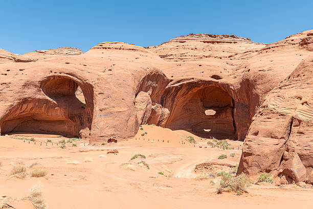 Sunlight through an eroded arch and desert rock Formations in Monument Valley, Arizona, USA