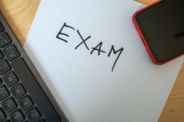 istock word exam written with black pen on paper 2208776682