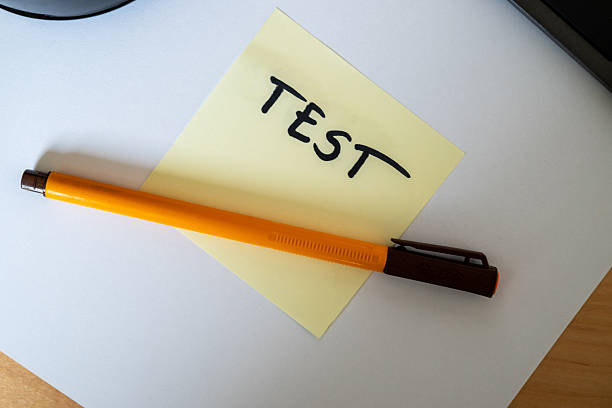 test word written on yellow card in pen symbolizing knowledge testing or exam