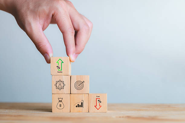 istock Hand Stacking Wooden Blocks with Growth Symbols on Light Background 2208780030