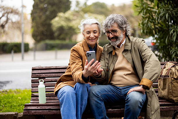istock Mature couple enjoying a city break and using smartphone 2208782169