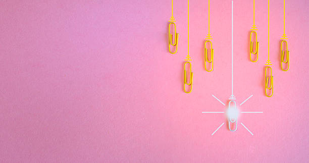istock innovation concept with paperclips,thinking outside the box,creativity and innovation with light bulb on pink background.Business and society concept, free copy negative space. 2208782412