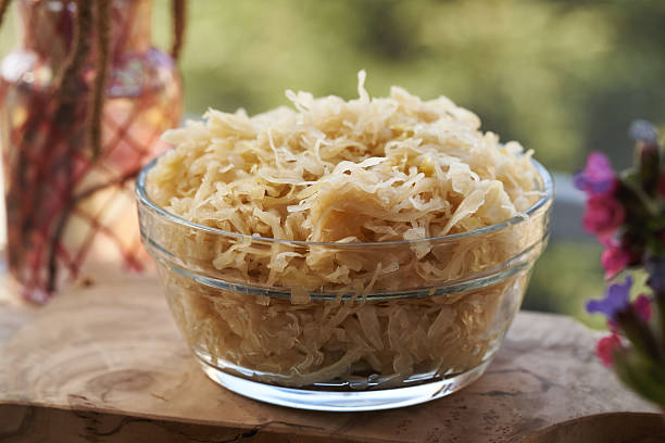 istock Fermented cabbage or sauerkraut in a glass bowl 2208787392