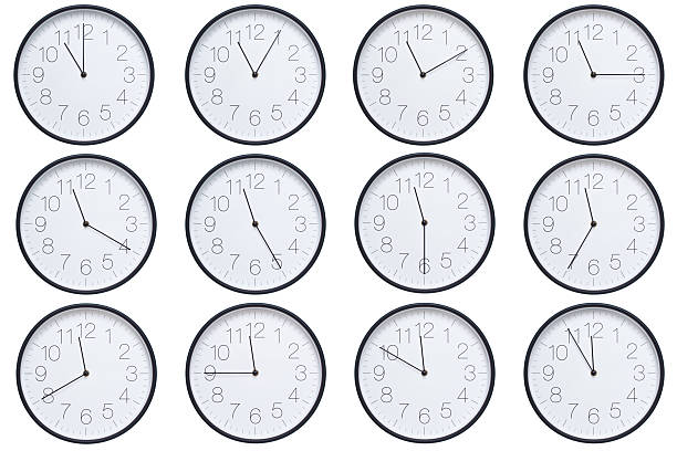 istock A set of twelve round wall clocks with dark brown frames and white faces showing 5-minute time intervals from 11:00 or 23:00 to 11:55 or 23:55. Clean white background, ideal for time, schedule, and deadline concepts. 2208790057