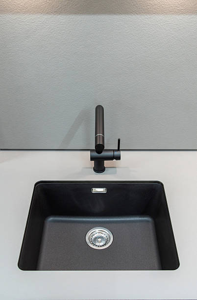 istock Black kitchen faucet and black sink 2208792310