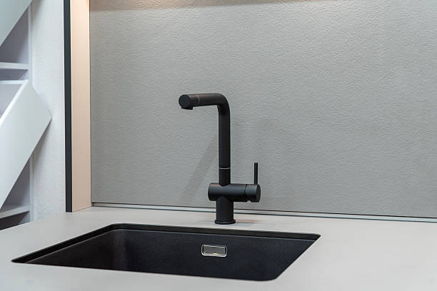 istock Black kitchen faucet and black sink 2208792311
