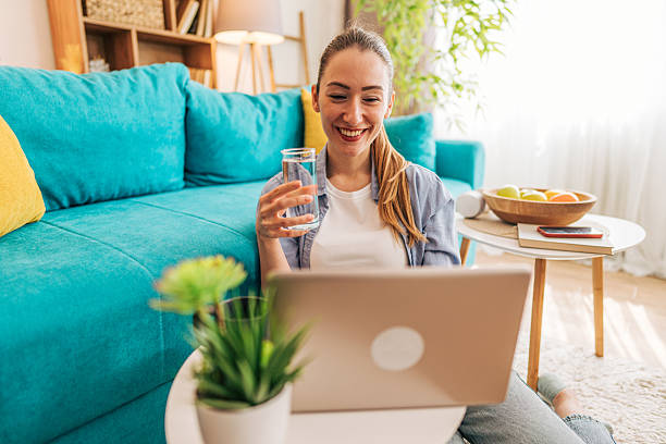 istock Young woman working from home and drinking water 2208792813