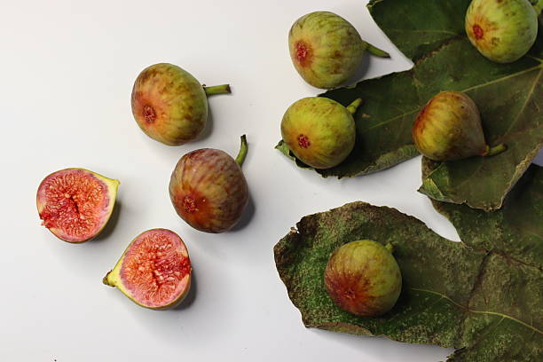 istock Fresh figs with green leaves on a white background 2208793371