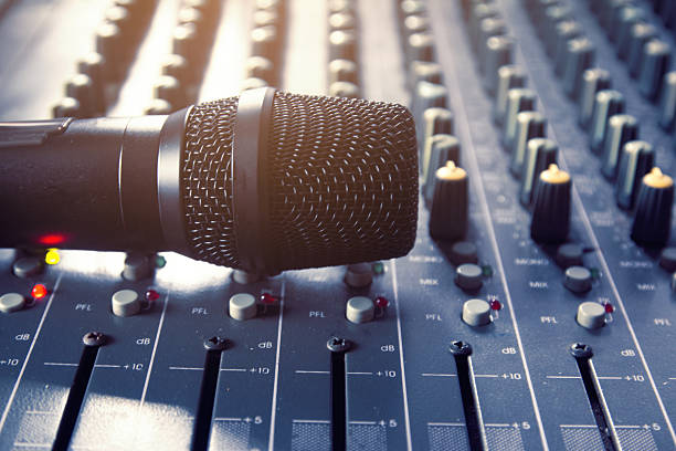 istock Digital wireless microphone on an analog audio mixer 2208796966
