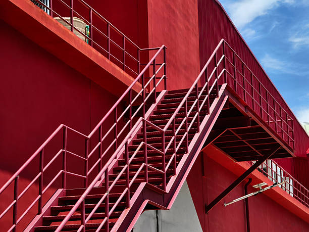 istock A set of stairs ascending a large red wall 2208800460