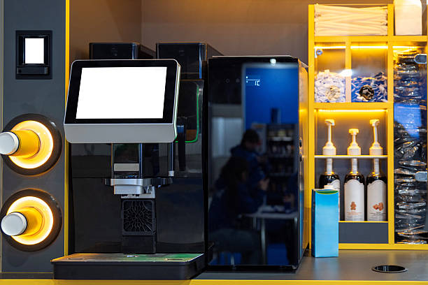 Vending coffee machine with screen and cup dispenser in self-service area