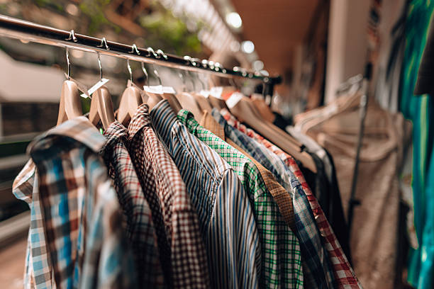 istock Shirts hanging on hangers in a store selling used clothes 2208805809