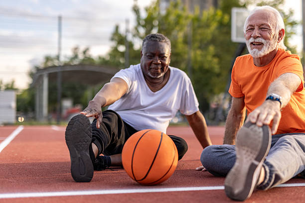 istock Two senior men stretching together before playing basketball 2208807263