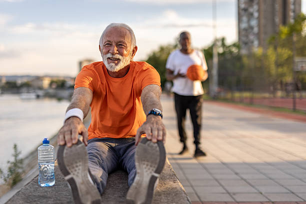 istock Senior man stretching legs after working out outdoors 2208807428