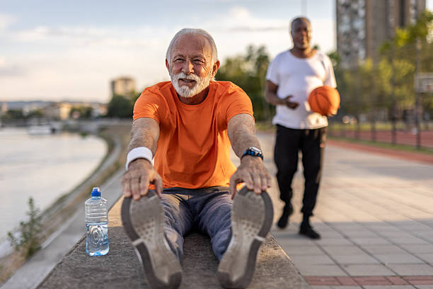 istock Senior man stretching legs after working out outdoors 2208807431
