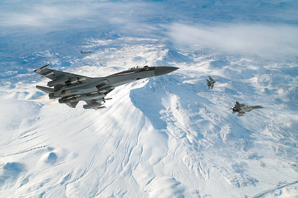 istock Air Force Fighter Jets flying over snowcapped mountains. High Above The Clouds. 2208810484