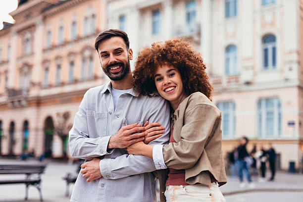 istock Young couple embracing in a city square 2208810536