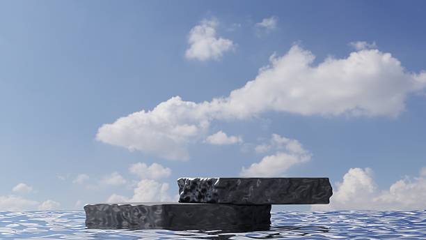 istock natural black stone podium display In Rippling Water with Puffy White Clouds, empty rock stage for product showcase, 3d rendering 2208811068