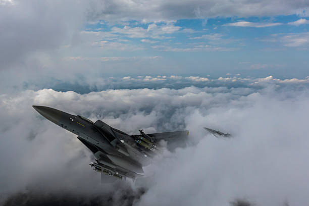 istock Air Force Fighter Jets flying over clouds. High Above The Clouds. 2208811324