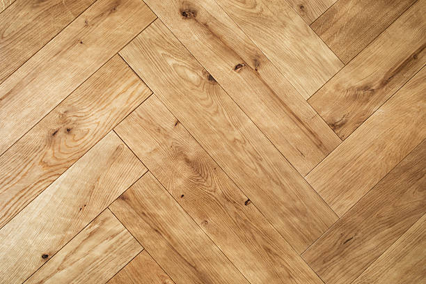 Natural wooden oak parquet flooring background. Rustic floor pattern for interior and indoor home design top view.