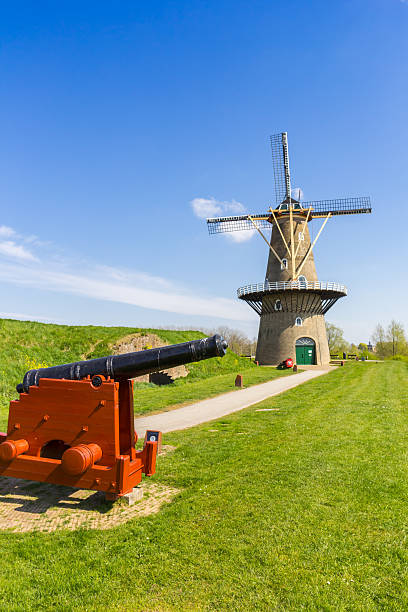 istock Historic cannon in front of an old windmill in Gorinchem 2208817990