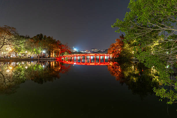 istock The iconic illuminated red bridge at night casting reflections over a calm lake in Hanoi, Vietnam. 2208822513