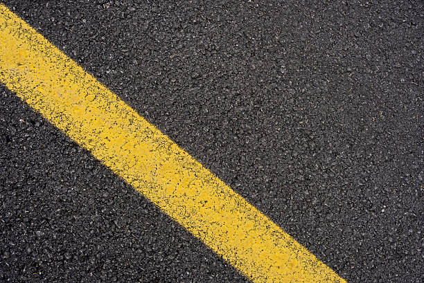 istock Close-up asphalt road texture with yellow line 2208825003