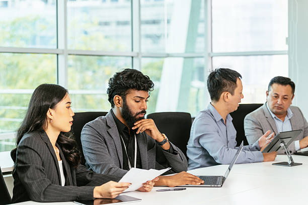 istock Diverse formal business people in office working on new financial project and using laptops and digital tablets 2208825959