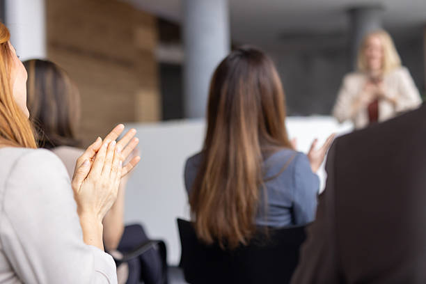 istock Audience Members Applauding After a Lecture Presentation 2208827224