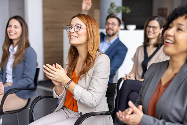 istock Smiling Individuals Applauding During a Professional Event 2208827231