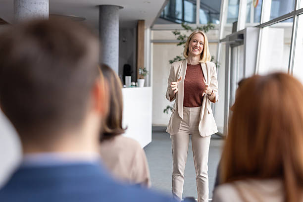 istock Smiling Speaker Presenting Ideas to an Engaged Audience 2208827248