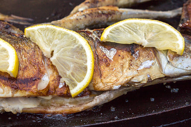 grilled spicy fish closeup. Cooking, the process. Fried fish for lunch or dinner. street food, fast food.