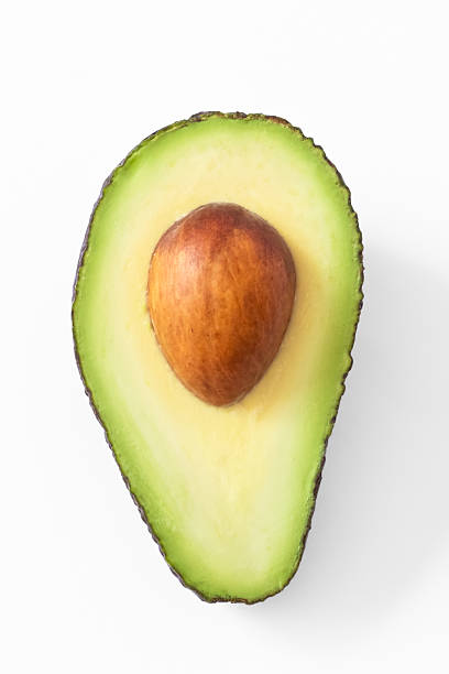 istock Avocado cut in half isolated on white background. clipping path. Vertical shot, close up 2208833322