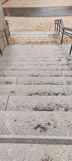 istock Concrete stairs with railings leading downward 2208834502