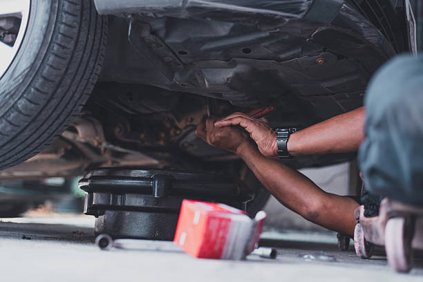 istock Mechanic working under car during oil change 2208837324