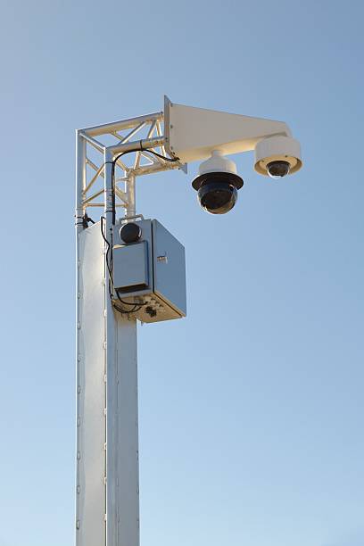 istock Surveillance cameras mounted on the pole with blue sky 2208839904