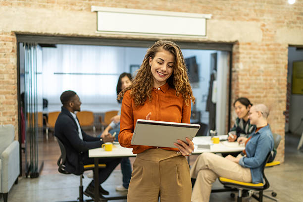 istock Confident young woman using digital tablet in creative office environment 2208840386