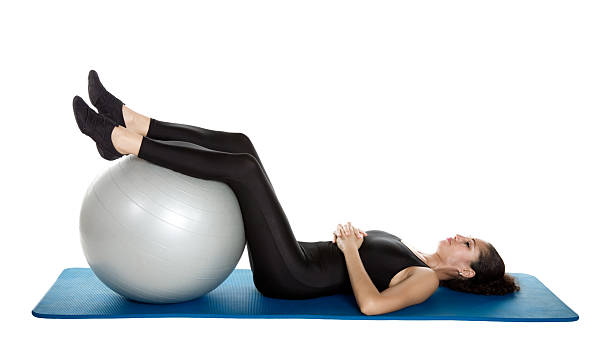 istock breathing with ball , Stott Pilates approach to original Pilates , core stability, spinal alignment, effective exercise 2208841194