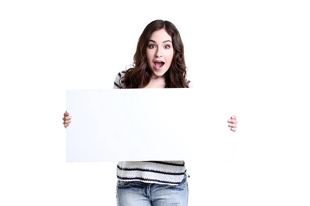istock Beautiful young woman holding white blank board 2208841997