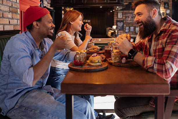 istock Pub Life at Its Best: Friends Laughing Over Drinks in Cozy Atmosphere 2208843835