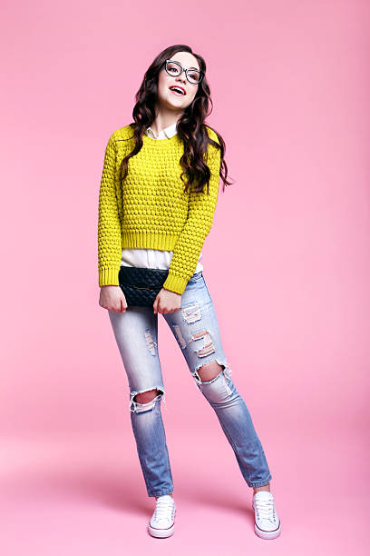 istock Young woman with black handbag on pink background 2208845041