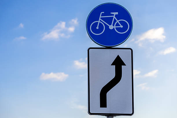 istock bike path traffic sign and curve direction arrow under blue sky with scattered clouds on sunny day road infrastructure symbol for cyclists navigation 2208845103